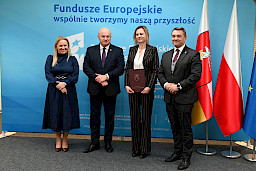 Uroczyste wręczenie umów o dofinansowanie projektów z funduszy europejskich na Integrację społeczną osób najbardziej potrzebujących wsparcia. Marszałek Jarosław Stawiarski z Beneficjentem projektu, który trzyma wręczoną umowę w dłoni.