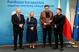 Uroczyste wręczenie umów o dofinansowanie projektów z funduszy europejskich na Integrację społeczną osób najbardziej potrzebujących wsparcia. Marszałek Jarosław Stawiarski z Beneficjentem projektu, który trzyma wręczoną umowę w dłoni.