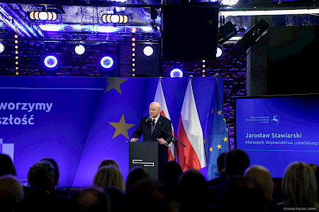 Marszałek Województwa Lubelskiego Jarosław Stawiarski przemawia do mikrofonu stojąc przy ambonie.