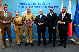 Przedstawiciele Zarządu Województwa Lubelskiego pozują do zdjęcia na ściance Funduszowej z beneficjentami projektu.