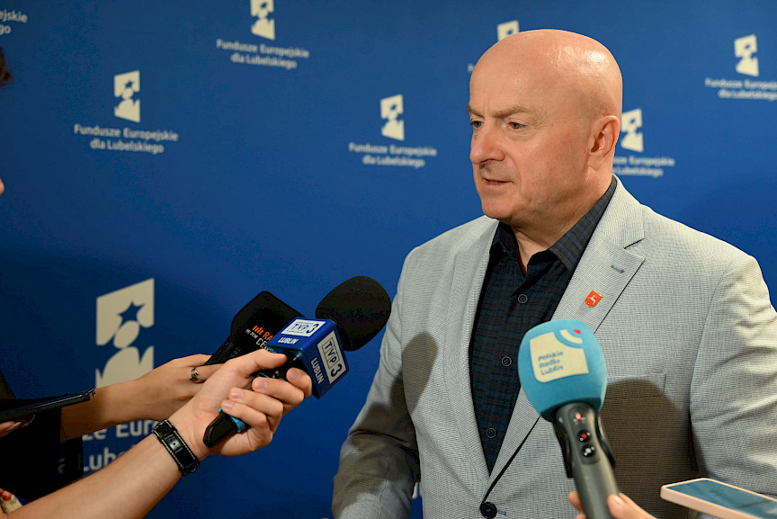 Marszałek Województwa Lubelskiego Jarosław Stawiarski udziela wywiadu mediom do mikrofonów.